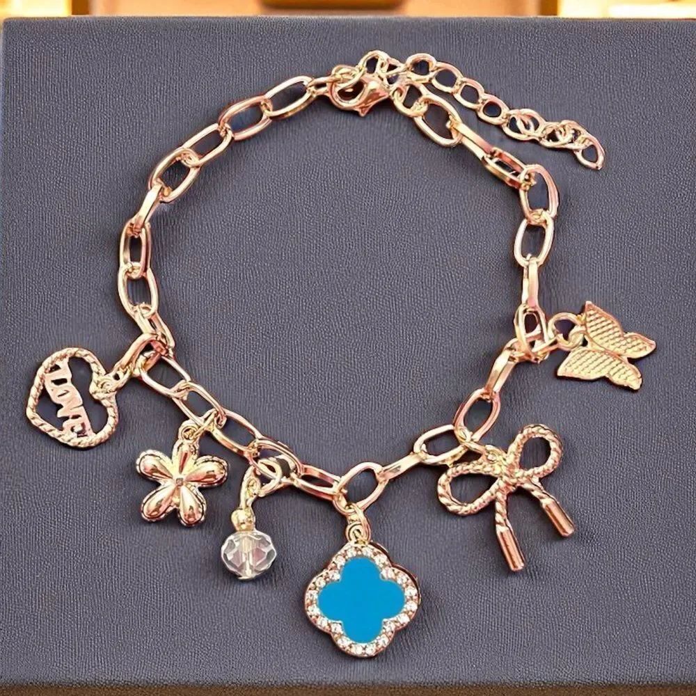 Gold Tone Charm Bracelet with Blue Clover Heart Bow Butterfly And Flower Charm